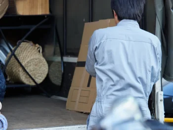 軽トラックの荷台に粗大ごみを積み込んでいる様子